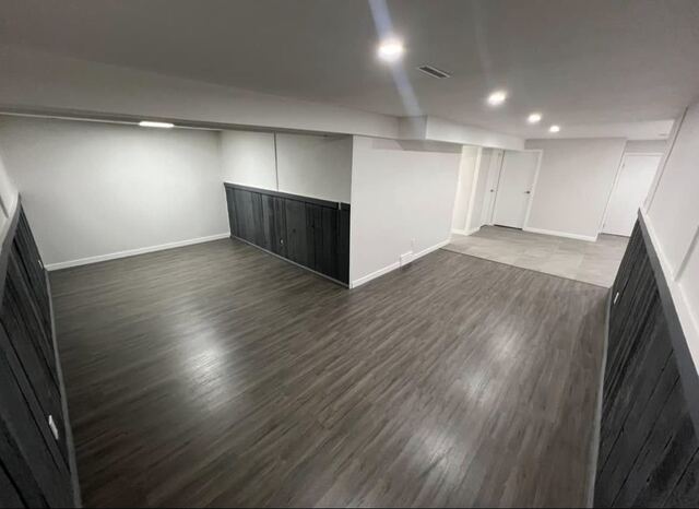 Finished basement with plank feature wall