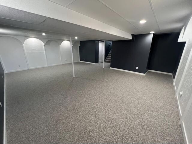 Finished basement with feature wall and arched nooks