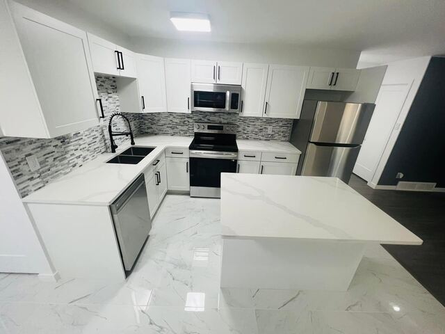 White kitchen with stainless appliances